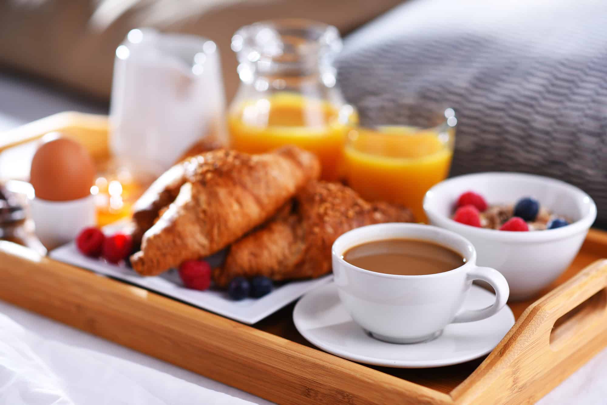 7 All-Inclusive Dining Mistakes Everyone Makes (And How To Avoid Them) 5 A tray with breakfast on a bed in a hotel room