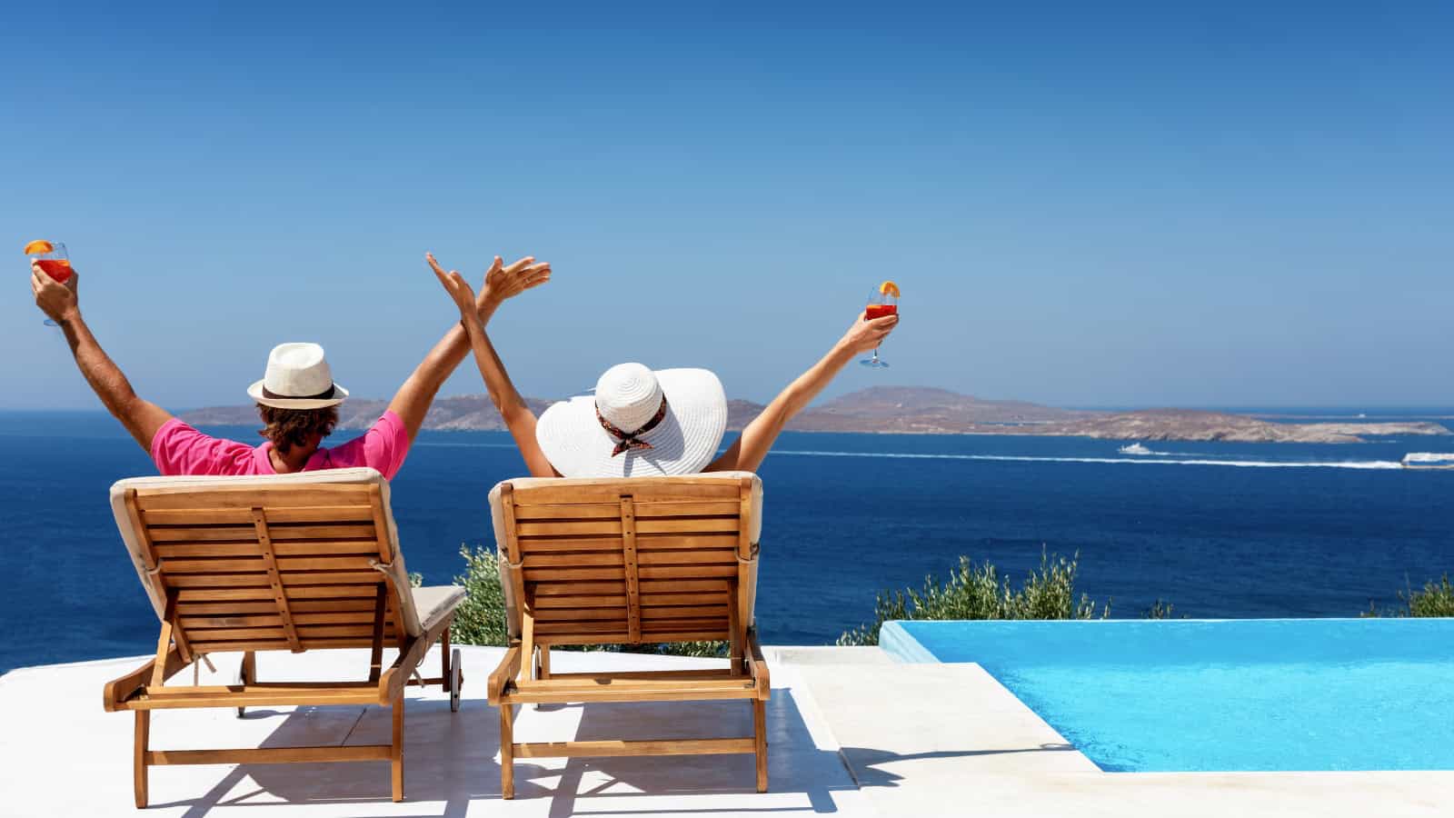 Couple enjoys their luxury vacation by the pool