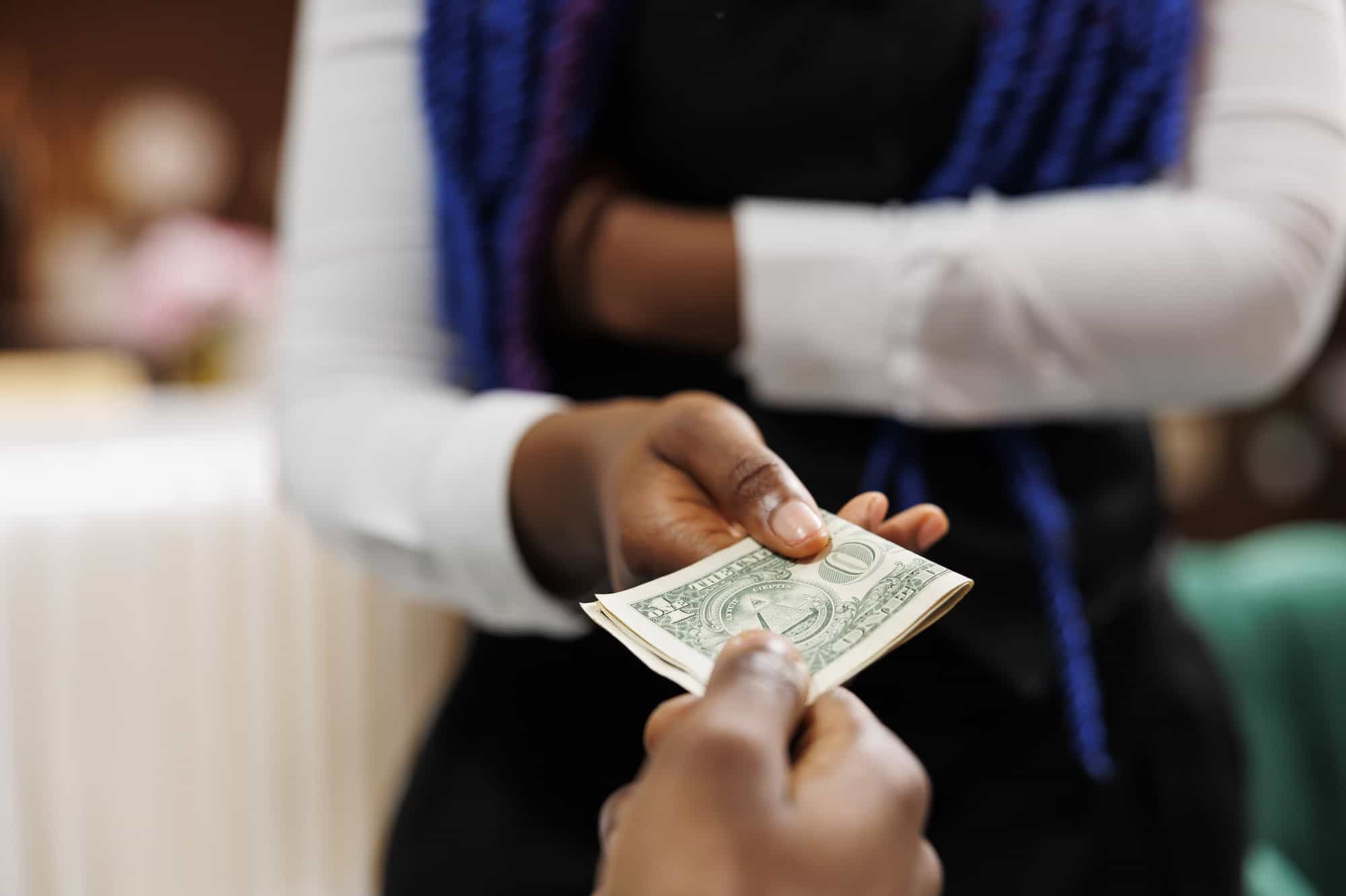 guest gives tips to hotel staff