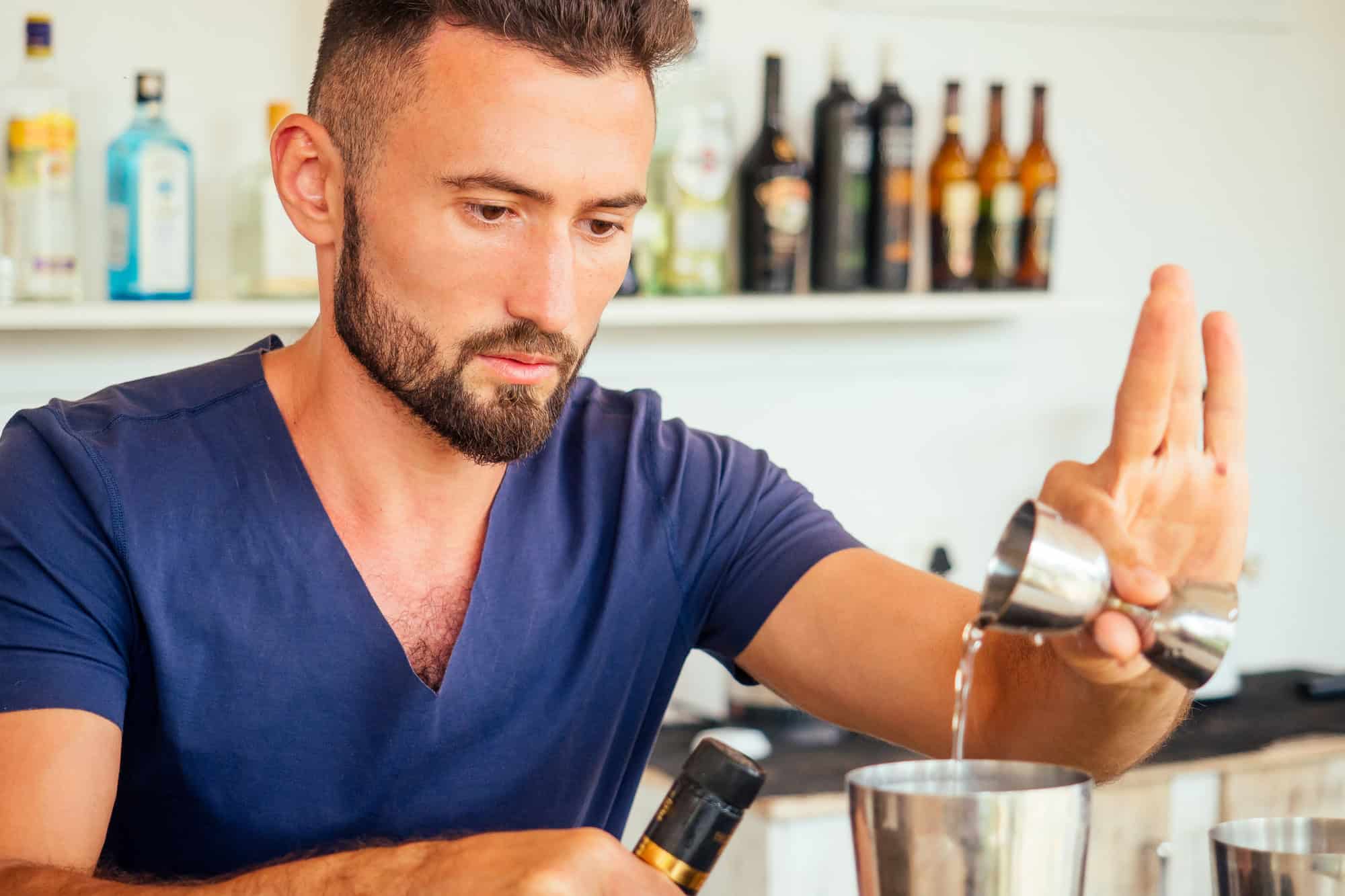 12 Things That Totally Annoy Poolside Bartenders – And What to Do Instead 1 Arabic man bartender making fresh coctail for lady