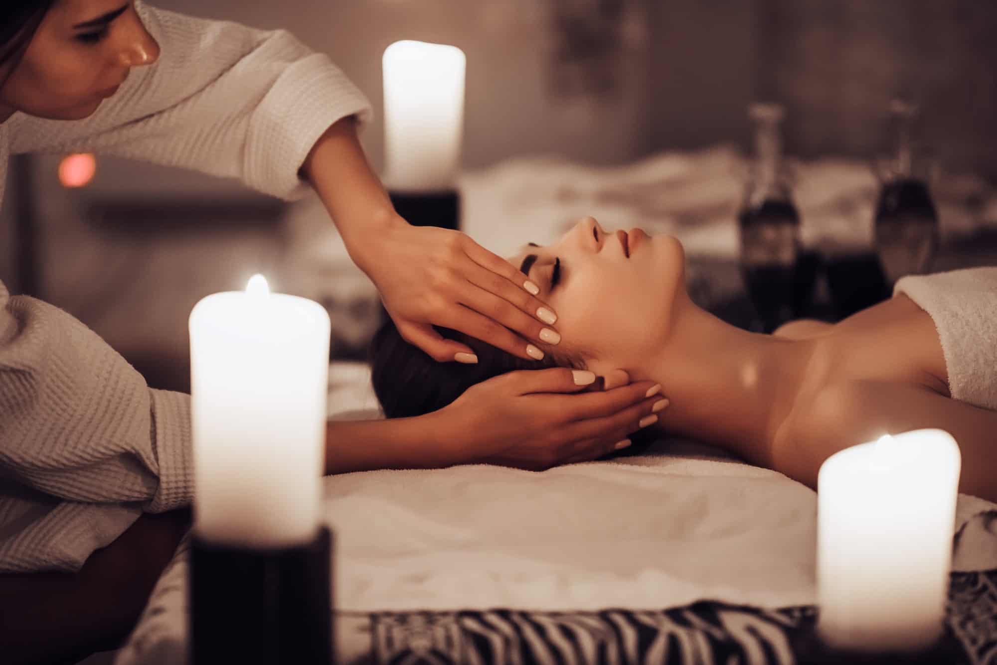 Here’s How Much Money People Spend on Spa Services at All-Inclusive Resorts 7 Attractive young woman is relaxing in spa and wellness center while receiving head massage. Beauty treatment concept.
