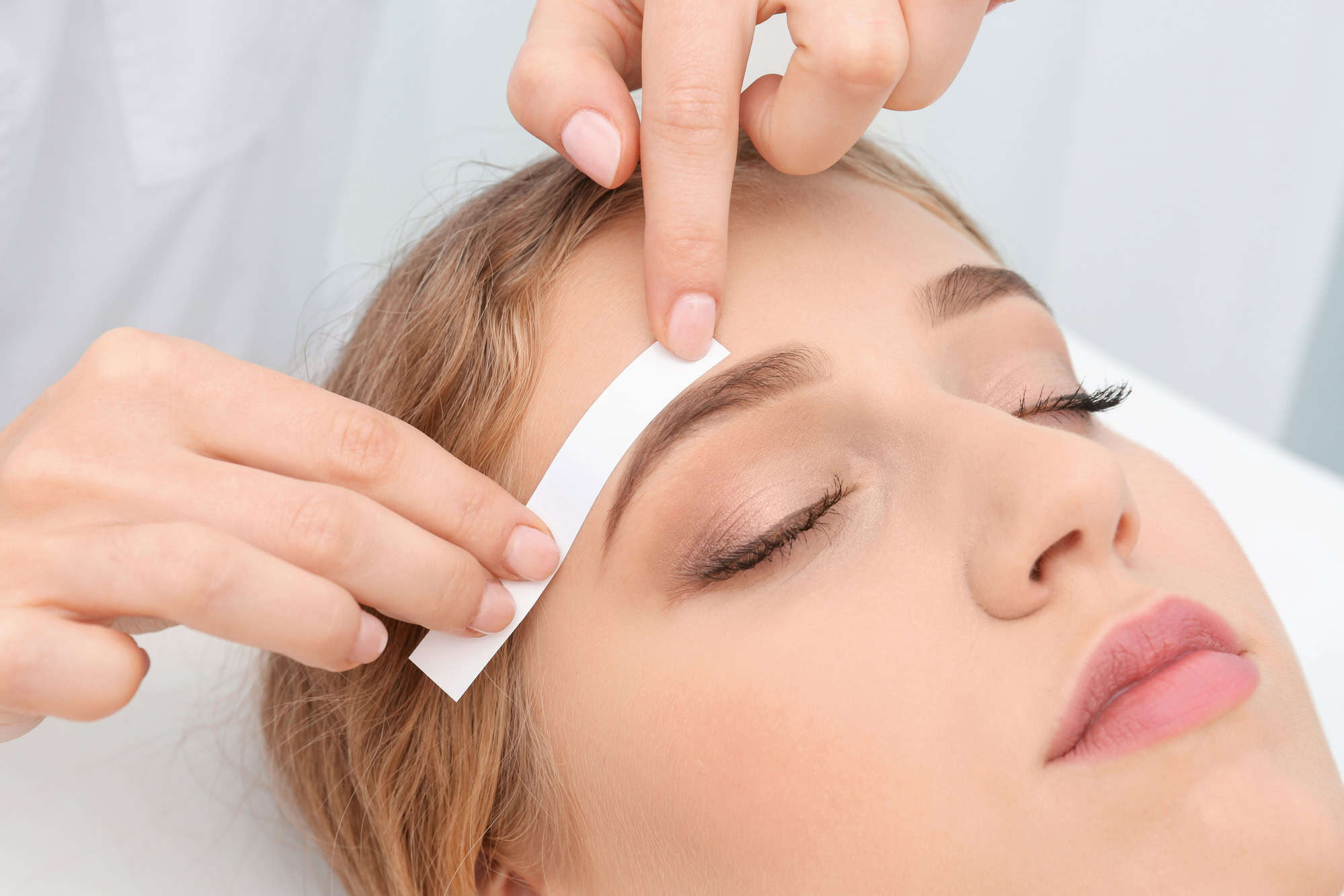 Here’s How Much Money People Spend on Spa Services at All-Inclusive Resorts 3 Young woman having eyebrow correction procedure