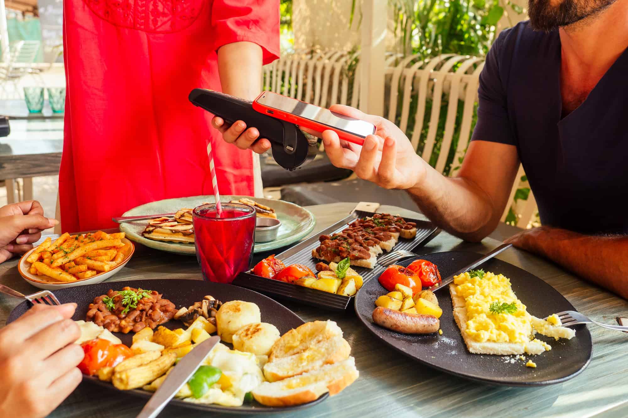 Here’s How Much Money People Spend on Off-Resort Excursions 4 man paying in restaurant