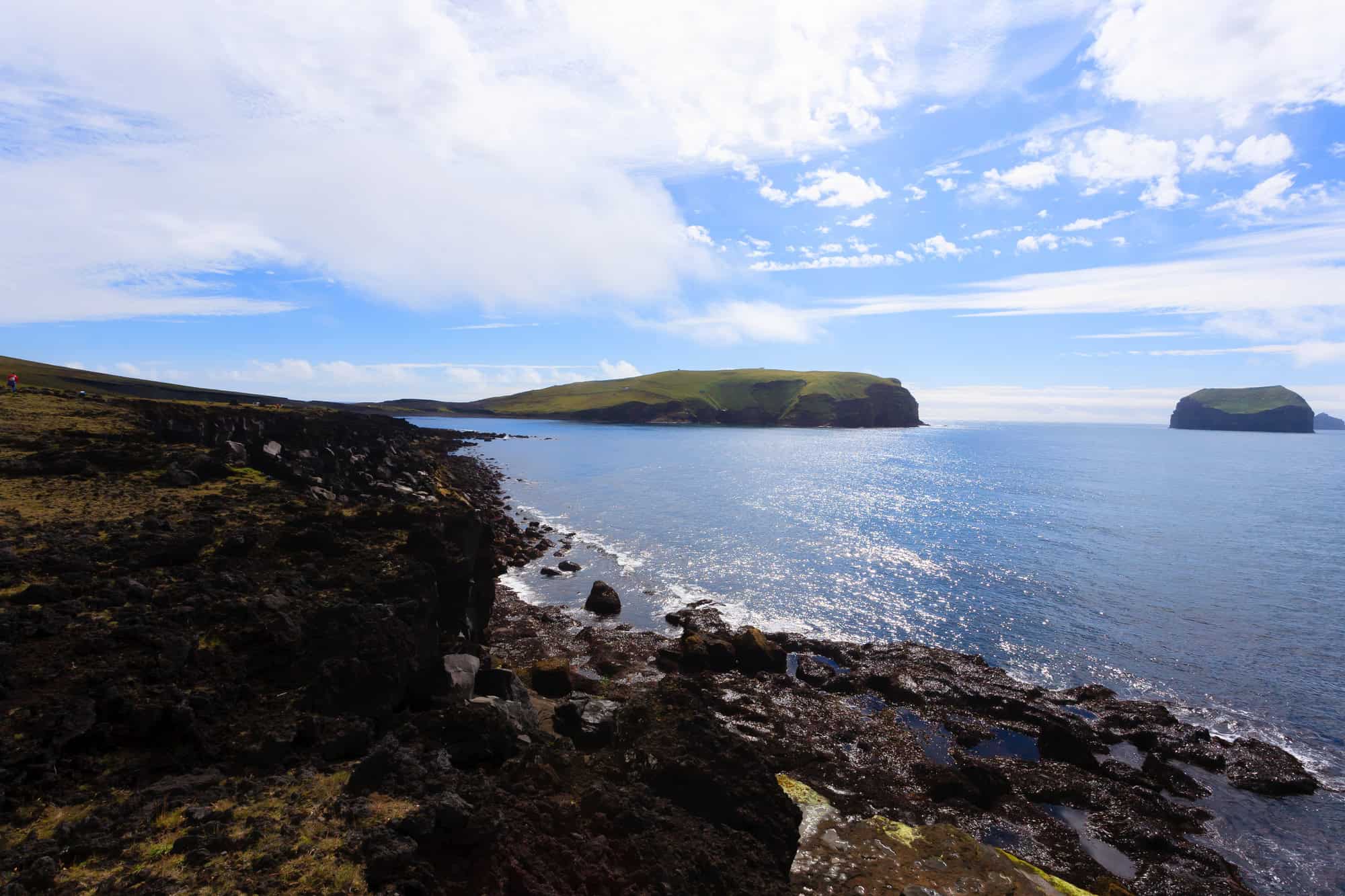 15 Places Tourists Are Banned From (And Why) 4 Vestmannaeyjar island beach view with Surtsey island in background. Iceland landscape